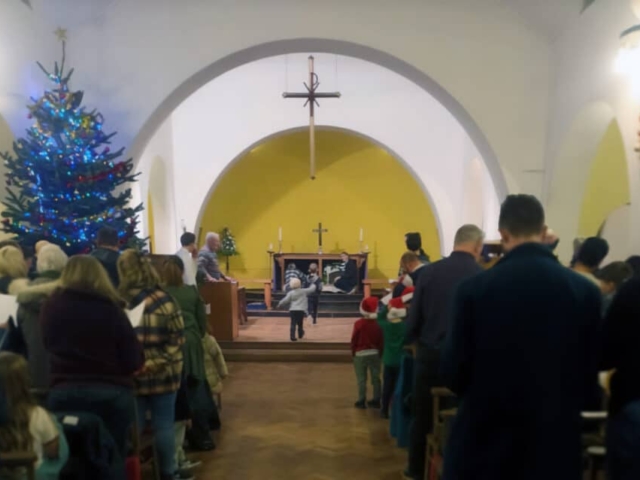 Photograph of St Michael's church inside during a Christmas service